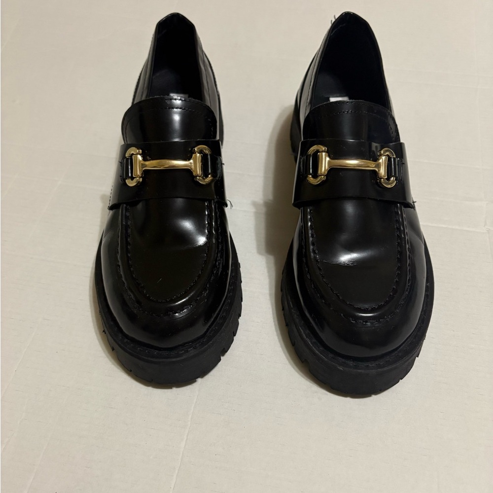Steve Madden Glossy Black Moccasins with Gold Accent